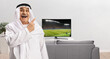 © Ljupco Smokovski - Happy mature arab man pointing at a football match on tv screen