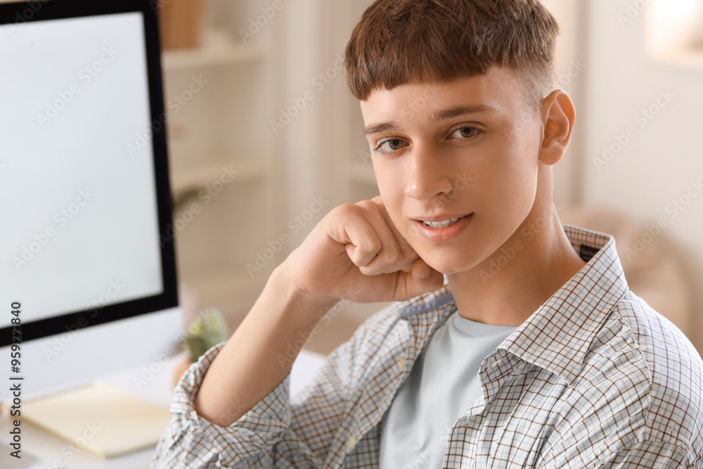 Young man sitting near table at home, closeup