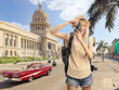 © Ljupco Smokovski - Female tourist with a backpack taking a photo in Havana