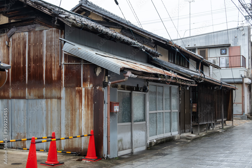 An old, traditional house in disrepair with a corrugated rusting metal ...