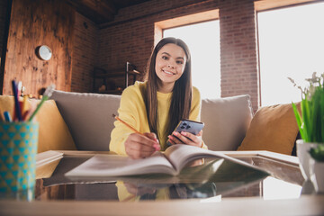 Wall Mural - Photo portrait of teen lady sit sofa do homework online lesson hold device dressed yellow garment spend pastime spacious house indoors room