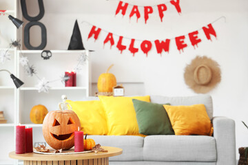 Poster - Halloween pumpkin with burning candles and autumn leaves on table in light living room