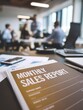 © melhak - Sales report document on table, background of business meeting in soft focus – financial performance, business presentation, team strategy session