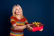 © deagreez - Photo of cheerful positive woman wear striped trendy clothes hold gift look up empty space isolated on dark blue color background