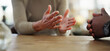 © WesLens/peopleimages.com - Hands, couple and angry in home, table and argument of people, fighting with accusation and drama. House, calm and miscommunication in relationship, conflict and fight in marriage, divorce or emotion