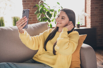 Sticker - Photo of nice teen lady sit couch take selfie photo tuck hair behind ear dressed yellow garment spend pastime spacious house indoors room