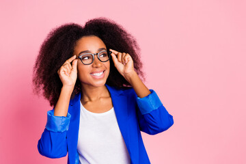 Photo of lovely successful girl wear stylish blue clothes look empty space isolated on pink color background