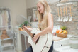 © ultramansk - A musician woman plays an acoustic guitar in a bright kitchen, combining the themes of domestic life and artistic expression, reflecting a relaxed lifestyle focused on creativity and comfort.
