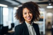 © Baba Images - Smiling portrait of a young African American businesswoman in office
