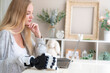 © ultramansk - A young woman is using a robotic prosthetic arm hand attached to her body to work on a desk. she is doing computer document and communication work. woman tries to control the smart arm in her home.