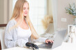 © ultramansk - A young woman is using a robotic prosthetic arm hand attached to her body to work on a desk. she is doing computer document and communication work. woman tries to control the smart arm in her home.