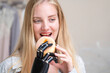 © ultramansk - A young woman is using a robotic prosthetic arm attached to her body. She controls her hand to pick up objects food donut. The woman tries to control the smart arm in her home.