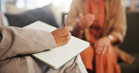 Book, counseling and hand of therapist writing notes for client with mental health evaluation. Paper, medical information and psychiatrist with patient for psychology assessment or review in office.