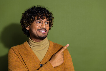 Poster - Photo portrait of attractive young man point look empty space dressed stylish brown clothes isolated on khaki color background