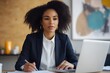 © irawan - Businesswoman working at a desk with a laptop and documents