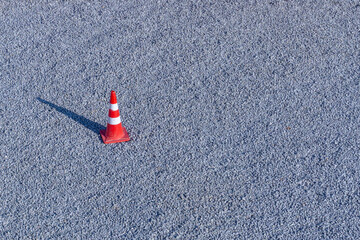 Red Traffic cone on ther gravel road background