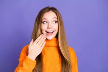 Poster - Portrait photo of youth charming blonde hair cute happy smile girl in orange turtleneck touch cheek amazed isolated on violet color background