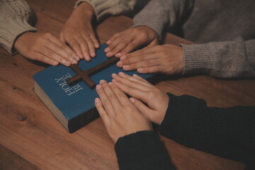 Christian group are praying to god with the bible and sharing the gospel. Concept of faith for god.