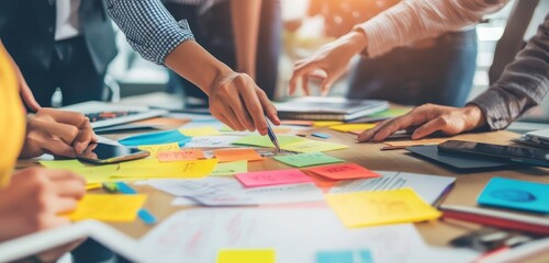 Poster - A team of people working together on a project, using sticky notes to brainstorm ideas.