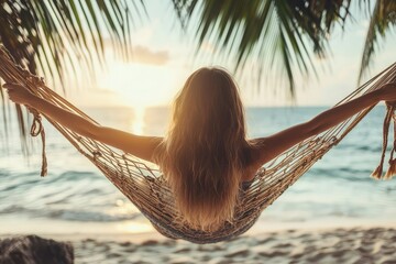 Canvas Print - a woman sitting in a hammock on the beach