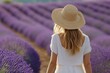 © Kevin - a woman in a hat walks through a lavender field