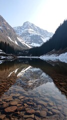 Crystal clear water reflects snow-capped mountain peaks in a tranquil alpine lake.