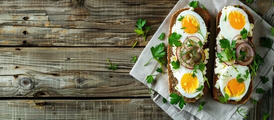 Open sandwich or smorrebrod featuring rye bread herring eggs caramelized onions parsley and cottage cheese on a rustic old wooden table A traditional Danish or Scandinavian lunch snack