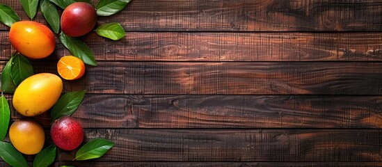 Poster - Mango and mangosteen Fresh tropical fruits Set against a wooden background Top view Copyspace