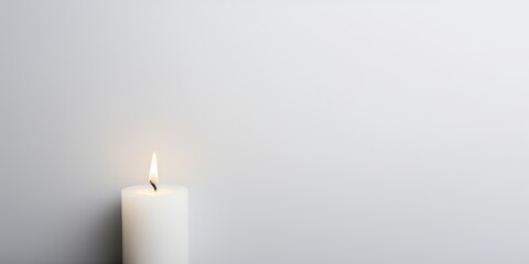 White background with white thin wax candle with a small lit flame for funeral grief death dead sad emotion with copy space texture for display products blank