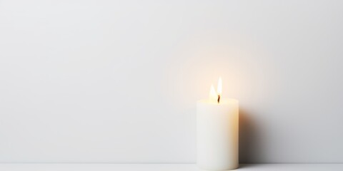 White background with white thin wax candle with a small lit flame for funeral grief death dead sad emotion with copy space texture for display products blank