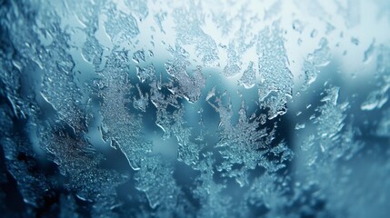 Abstract blue texture of frost on a window, blurred background.