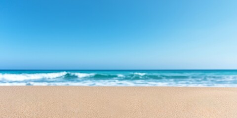 Wall Mural - close-up of soft, golden sand beach with blurred turquoise ocean and clear blue sky - perfect for summer vacation, travel, and coastal lifestyle designs.