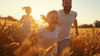 © Abelorz - Cinematic photograph of happy family running in the wheat field at sunset, mother and father with little daughter laughing and having fun together on a summer day. Happy family concept.