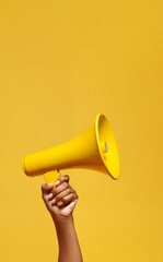 Yellow megaphone on a yellow back.