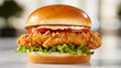 © Kraiwit - crispy chicken fillet topped with lettuce, tomato, and mayo, served on a toasted brioche bun