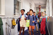 © Rido - Multiethnic school kids running in a primary hallway