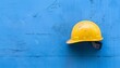 © Oleg - Yellow Construction Helmet Blue Backdrop