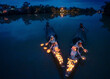 © Travel 'n' Lifestyle - View of graceful vietnamese ladies in ao dai with glowing lanterns on a tranquil river at dusk, Hue, Vietnam.