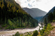 © Travel 'n' Lifestyle - View of beautiful mountainous landscape with a winding river and lush green forest, Kashmir, Pakistan.