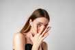 © fotofabrika - Young Woman With Long Brown Hair Covering Her Eyes With Her Hands