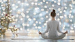 © 18042011 - Woman practicing yoga in a peaceful Christmas setting, soft bokeh lights and decorated tree in background, tranquil meditation during festive season, mindfulness concept.