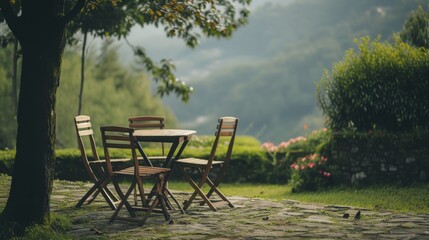 Tranquil scene of a wooden table and chairs set on a stone patio in a lush, green garden. The sunlight filtering through the trees creates a peaceful ambiance perfect for relaxation.