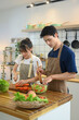 © Prathankarnpap - Lovely young couple wearing aprons cooking a healthy vegan meal in their kitchen at home