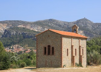 Chapel Des Paintes Puelles with view of nearby town of Tautavel and Tour del Far on hilltop. Pyrénées-Orientales department, southern France