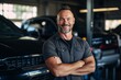 © CojanAI - Portrait of a middle aged male car mechanic in workshop