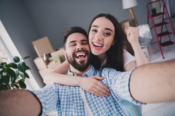 Sticker - Photo of two young partners make selfie raise fist relocating moving box package new modern flat indoors