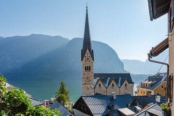 Wall Mural - A serene morning in Hallstatt, Austria with mountains and steeple by the tranquil lake