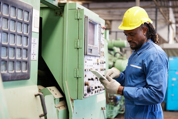 engineer or technician checking and control lathe machine in the factory