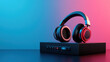 © khonkangrua - Wireless headphones resting on a sleek audio player, highlighted by vibrant blue and pink lighting, creating a modern tech vibe.