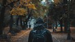 © LAYHONG - A mysterious hooded figure walking alone through an autumn park, surrounded by golden leaves and a moody atmosphere..